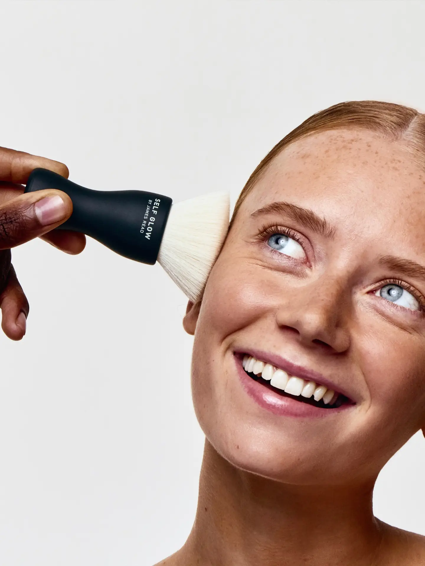 Saltco-directed beauty shot showing Self Glow brush applied to model’s cheek during product use