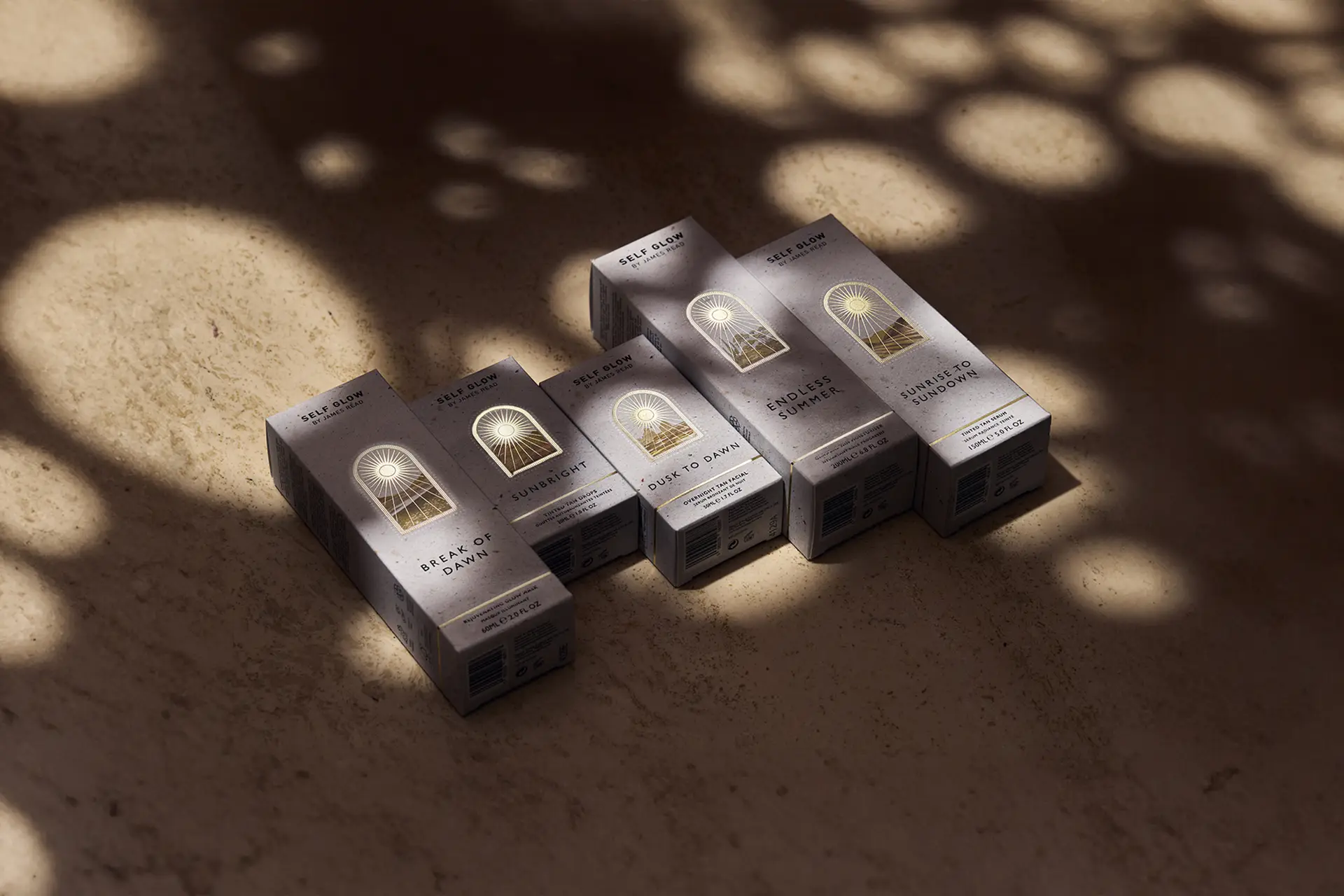 Packaging design for Self Glow’s full product range captured in soft natural light; creative direction and layout by Saltco